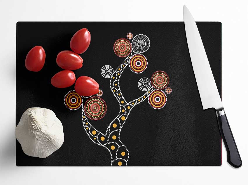 Aboriginal Tree 1 chopping board made of tempered glass with a chinchilla ripple effect and anti-slip feet.